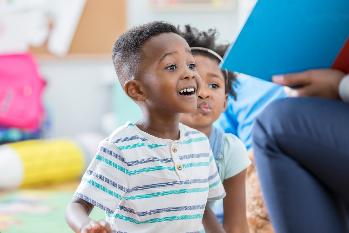 Excited preschool boy enjoying story time