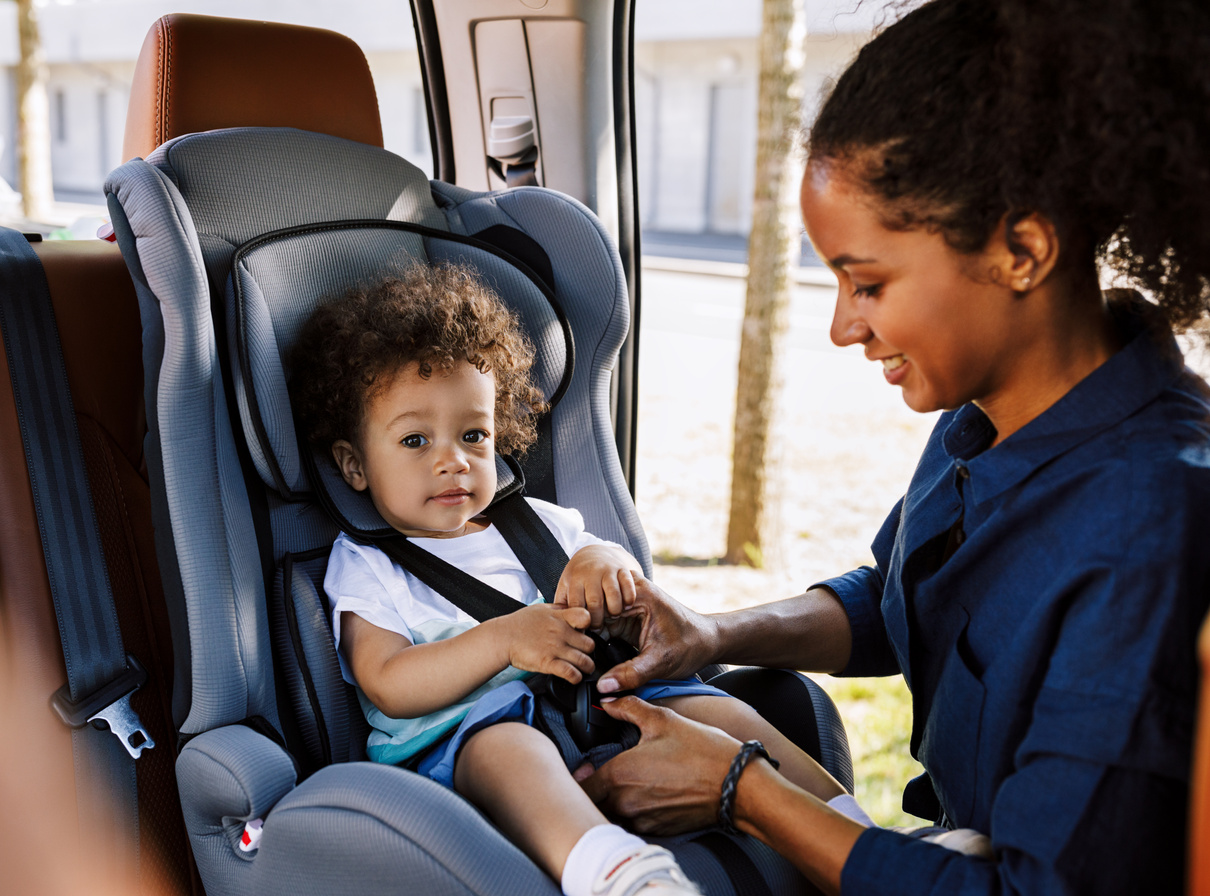 Mom Putting Son in a Car Seat